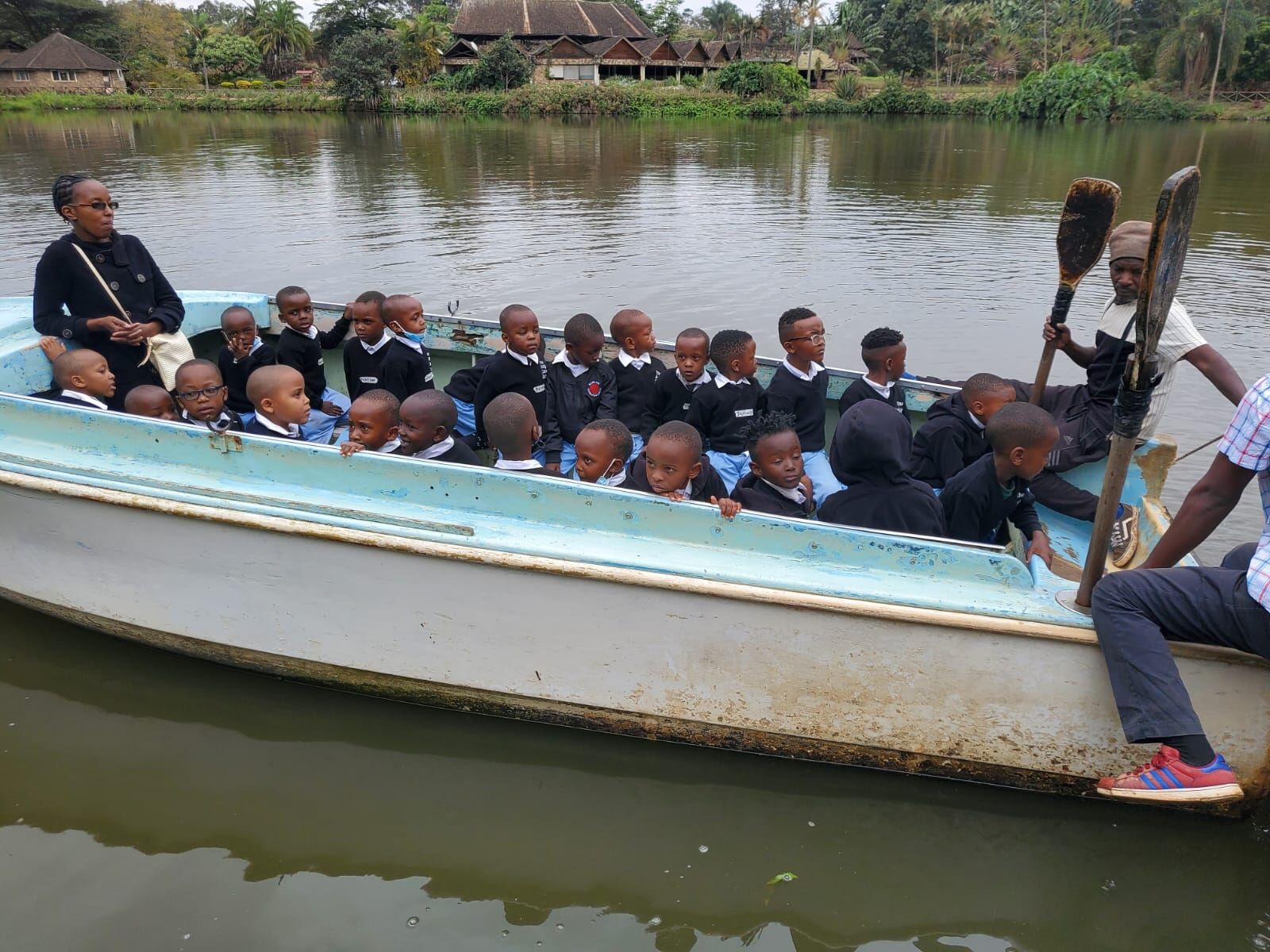 Young pupils in a boat on a lake during an educational outing
